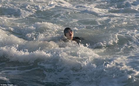 Terrifying moment a drowning swimmer is plucked from the surf by hero lifesavers | Daily Mail Online