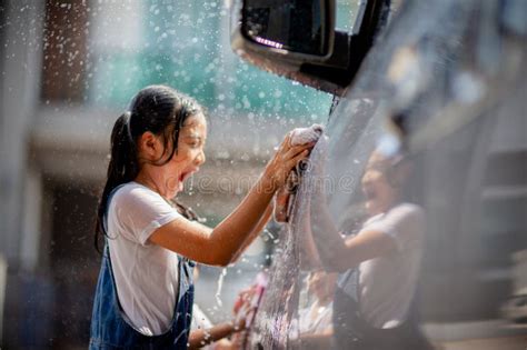 Sibling Asian Girls Wash Their Cars And Have Fun Playing Indoors On A Hot Summer Day Stock Image