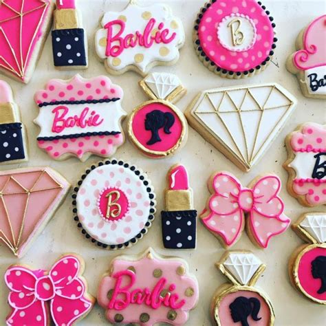 Decorated Cookies Are Arranged On A Table With Pink And Black Accents