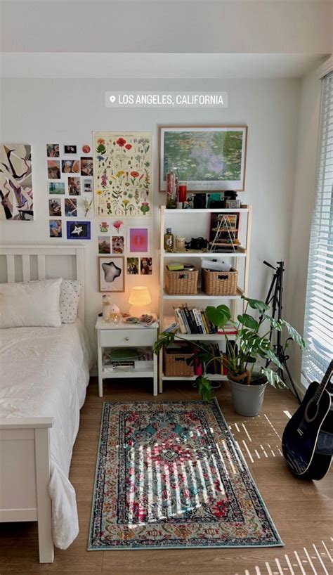 A Bed Room With A Neatly Made Bed And A Guitar