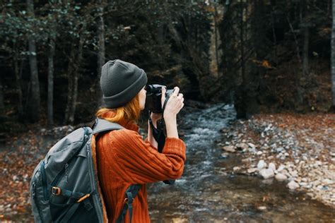 Premium Photo Woman Tourist Photographing Nature River Forest Mountains