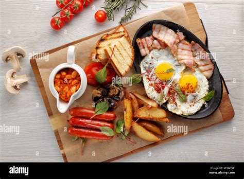 Close Up Of Rustic Full English Breakfast On A White Wooden Table Stock