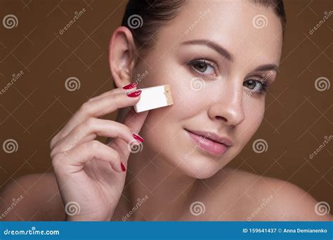 Brunette Caucasian Woman Apply Foundation With A Sponger Flawless