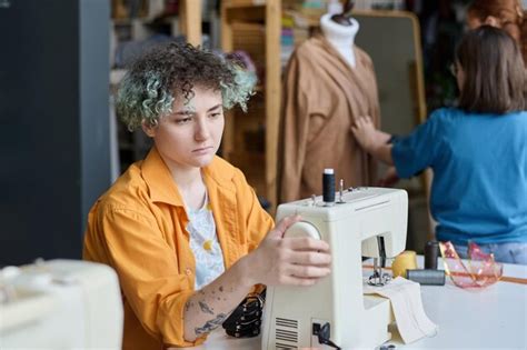 Premium Photo Girl Setting Up Sewing Machine In Tailoring Class