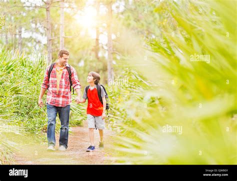 Father And His Son Walking Together Holding Hands Hi Res Stock