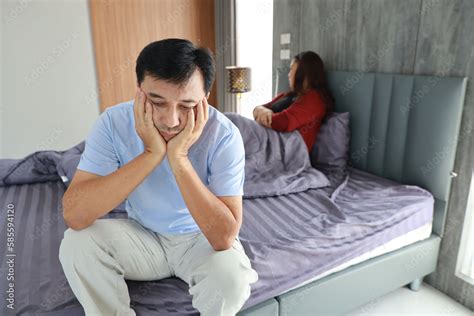 Sad Frustrated Middle Aged Asian Man Sit On Bed After Having Sex While His Hands Touching Head