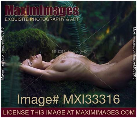 Photo Of Beautiful Nude Woman Lying Relaxed On A Mossy Tree In Green Forest With Rain Drops On