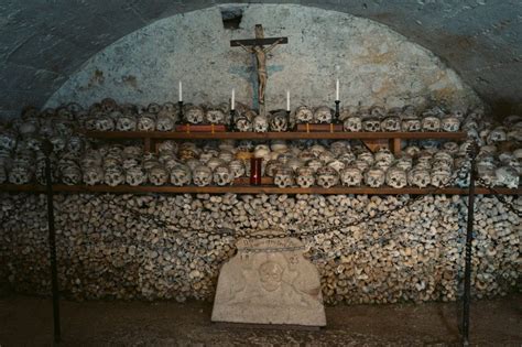 Painted Skulls And A Cross At The Charnel Haus Beinhaus In Hallstatt