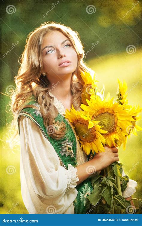 Young Girl Wearing Romanian Traditional Blouse Holding Sunflowers