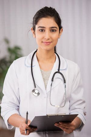 Indian Doctor Wearing A White Coat With A Tablet Stock Photo Picture