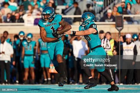 Ethan Vasko Of The Coastal Carolina Chanticleers Hands The Ball To