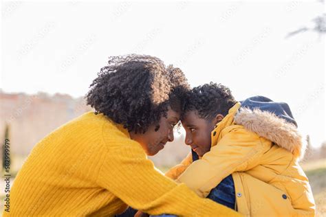 Affectionate Mother And Son Touching Foreheads In Park Stock Photo