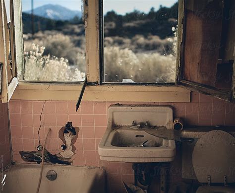 An Abandoned And Vandalized Bathroom With A Majestic Desert View By Stocksy Contributor