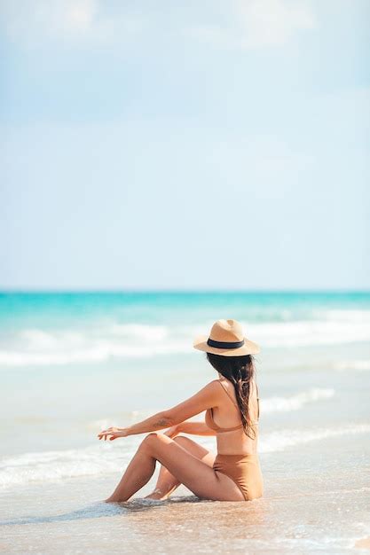 Premium Photo | Young happy woman on the beach enjoy her summer ...