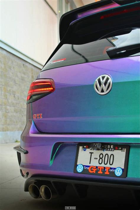 The Back End Of A Purple And Green Volkswagen Car With Its Trunk Open