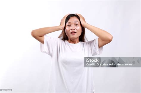 Portrait Of Shocked Anxious Asian Woman In Panic Holding Hands On Head