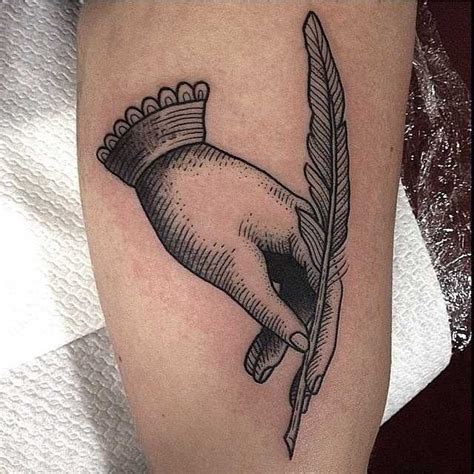 Woodcut Style Tattoo Of A Hand Holding A Feather By Susanne K Nig