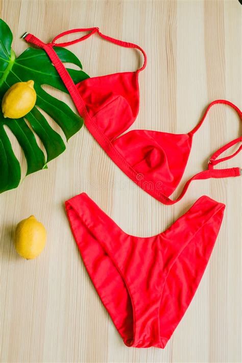 Bright Trendy Bikini On A Wooden Background With Yellow Lemons