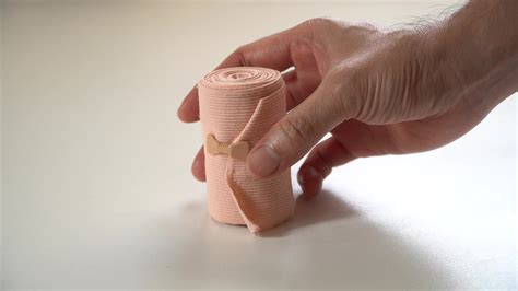 Male Hand Holding A Medical Bandage Roll Medical Bandage Roll Elastic