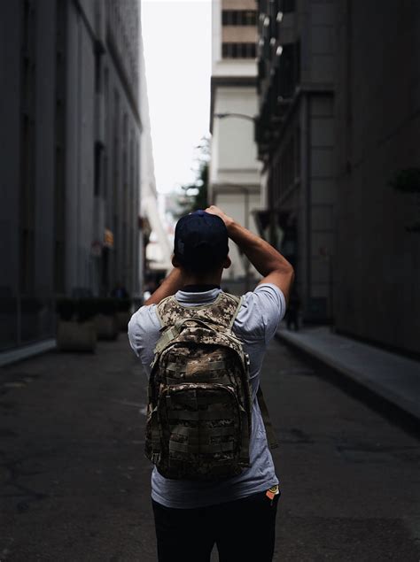 Royalty Free Photo Man Wearing Cap And Backpack Standing Between