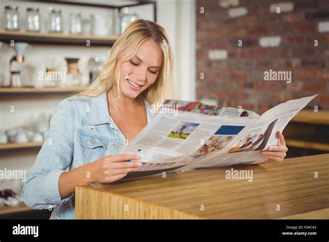 Smiling Blonde Reading Newspaper Stock Photo Alamy