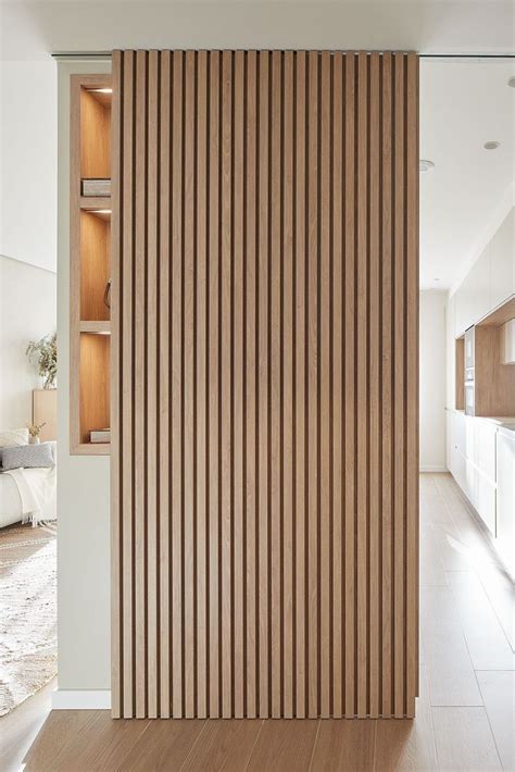 The Interior Of A Modern Home With Wood Slats On The Wall And Wooden