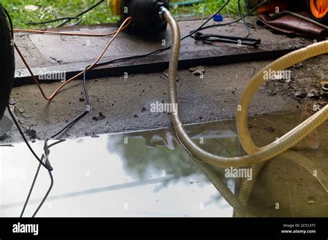 A water pump removing water in a basement after flood Stock Photo - Alamy