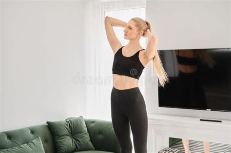 Active Blonde Woman Does Twisting Exercises At Home Stock Photo Image Of Active Energy