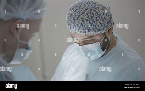 Team Of Professionals Performing Operation In Surgery Theatre Action