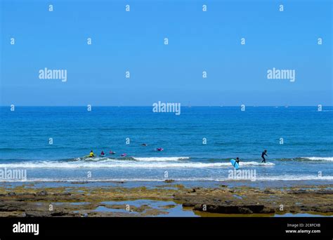 Surfing on Playa De Las Americas beach Stock Photo - Alamy