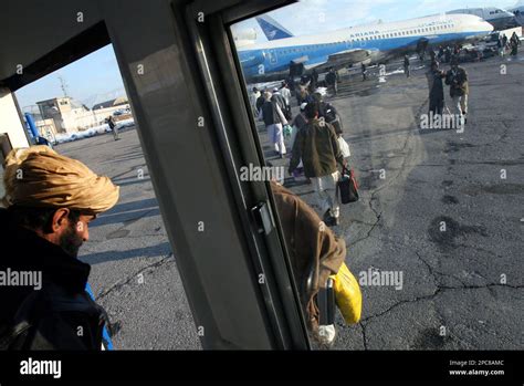 Passengers Walk Towards An Airplane For A Flight To Dubai At Kabul