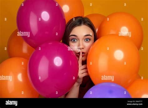 Smiling Caucasian Girl Posing With Bright Color Air Balloons Showing Silence Gesture Beautiful