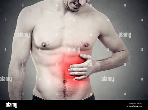 Muscular Man With Stomach Pain On Gray Background Stock Photo Alamy