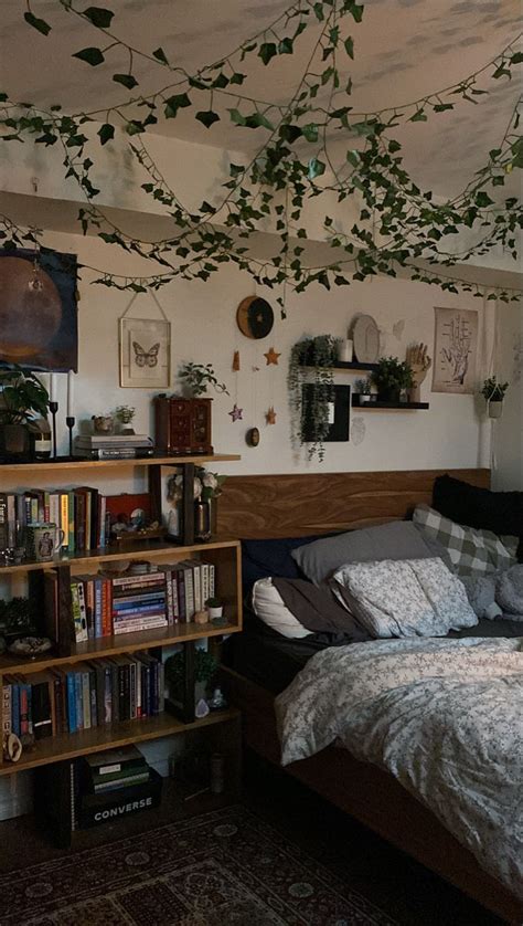 A Bed Room With A Neatly Made Bed And Lots Of Books On The Shelves Next