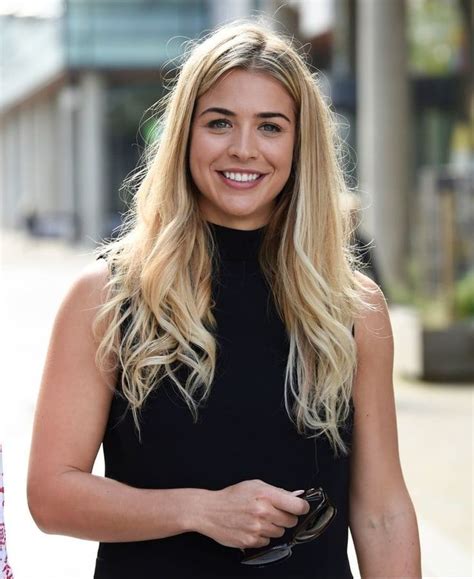 A Woman With Long Blonde Hair Smiling At The Camera