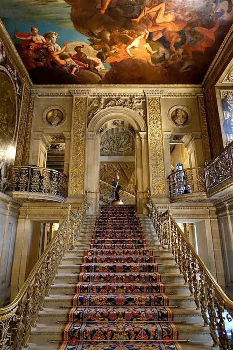 An Ornate Staircase Leading Up To A Painting On The Ceiling