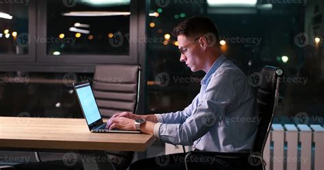 man working on laptop in dark office 11260343 Stock Photo at Vecteezy