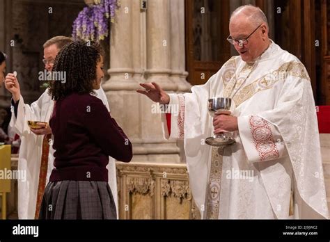 Cardinal Timothy Dolan Blesses A High School Senior At Mass With Nearly