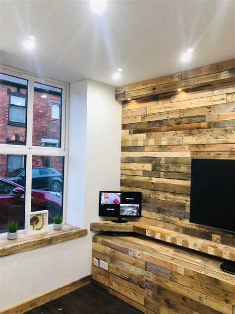 A Flat Screen Tv Sitting On Top Of A Wooden Shelf In A Living Room Next