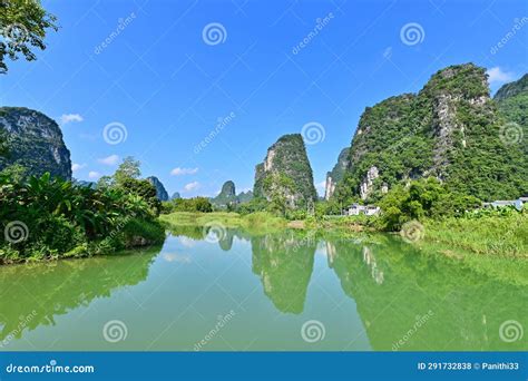 Karst Landscape With Reflection On Water Of Mingshi Pastoral Scenic