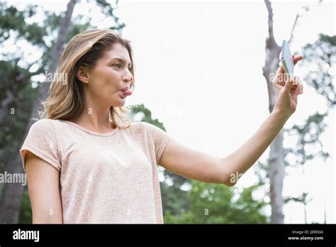 Smiling Woman Taking Selfies Stock Photo Alamy