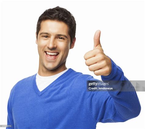 Handsome Young Man Gesturing Thumbs Up Isolated High Res Stock Photo