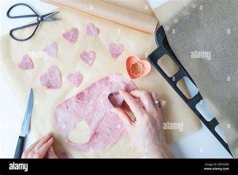 The chef cuts a heart-shaped sausage-ham cut into a heart-shaped shape ...