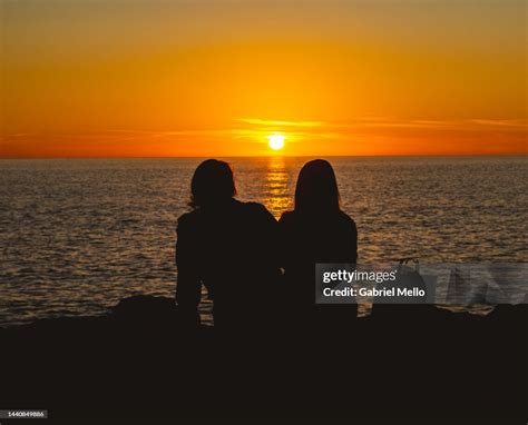 Silhouette Of Friends Watching Sunset High-Res Stock Photo - Getty Images