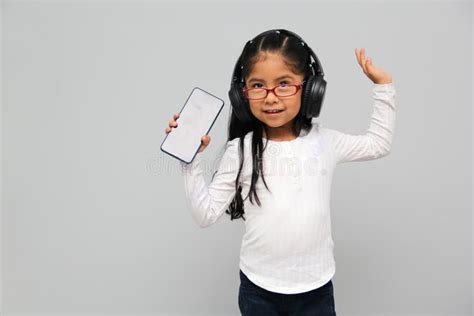 Year Old Brunette Latin Girl With Glasses Listens To Music In Her Headphones Connected To Her