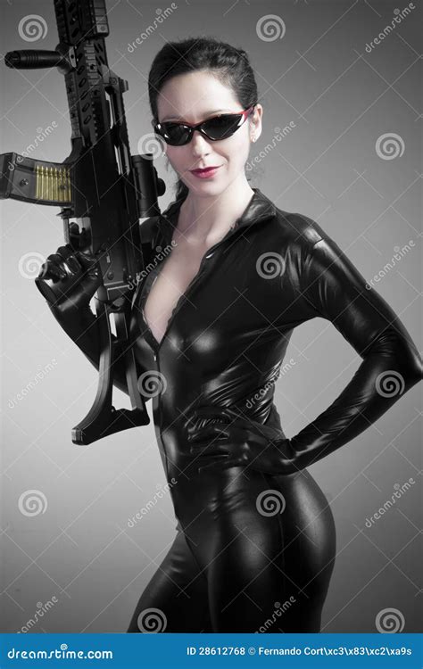 Brunette Woman In Latex Jumpsuit With Heavy Gun Stock Photo Image Of Side Female 28612768