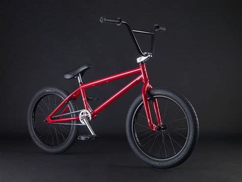 a red bike is shown against a black background