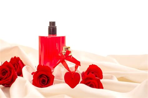 Premium Photo Bottles Of Perfume Red Roses Decorative Hearts On The Satin Fabric Cosmetics