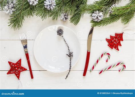 Empty Plate Knife And Fork Candy Canes And Christmas Decorations On