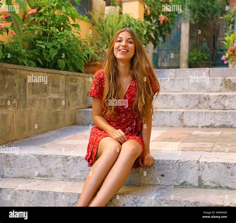 Attractive Beautiful Young Woman Sitting On Street Stairs In Cozy